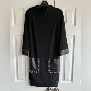 Joseph Ribkoff Black dress with faux leather studded pockets and bottom trim.